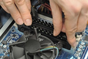 Hands installing computer parts